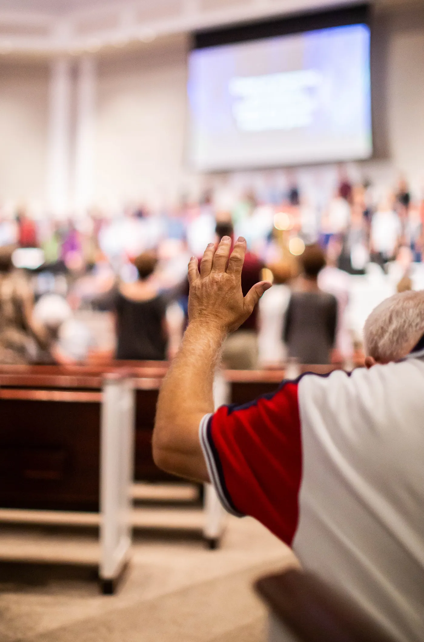 A worshipper raising a hand during a church service