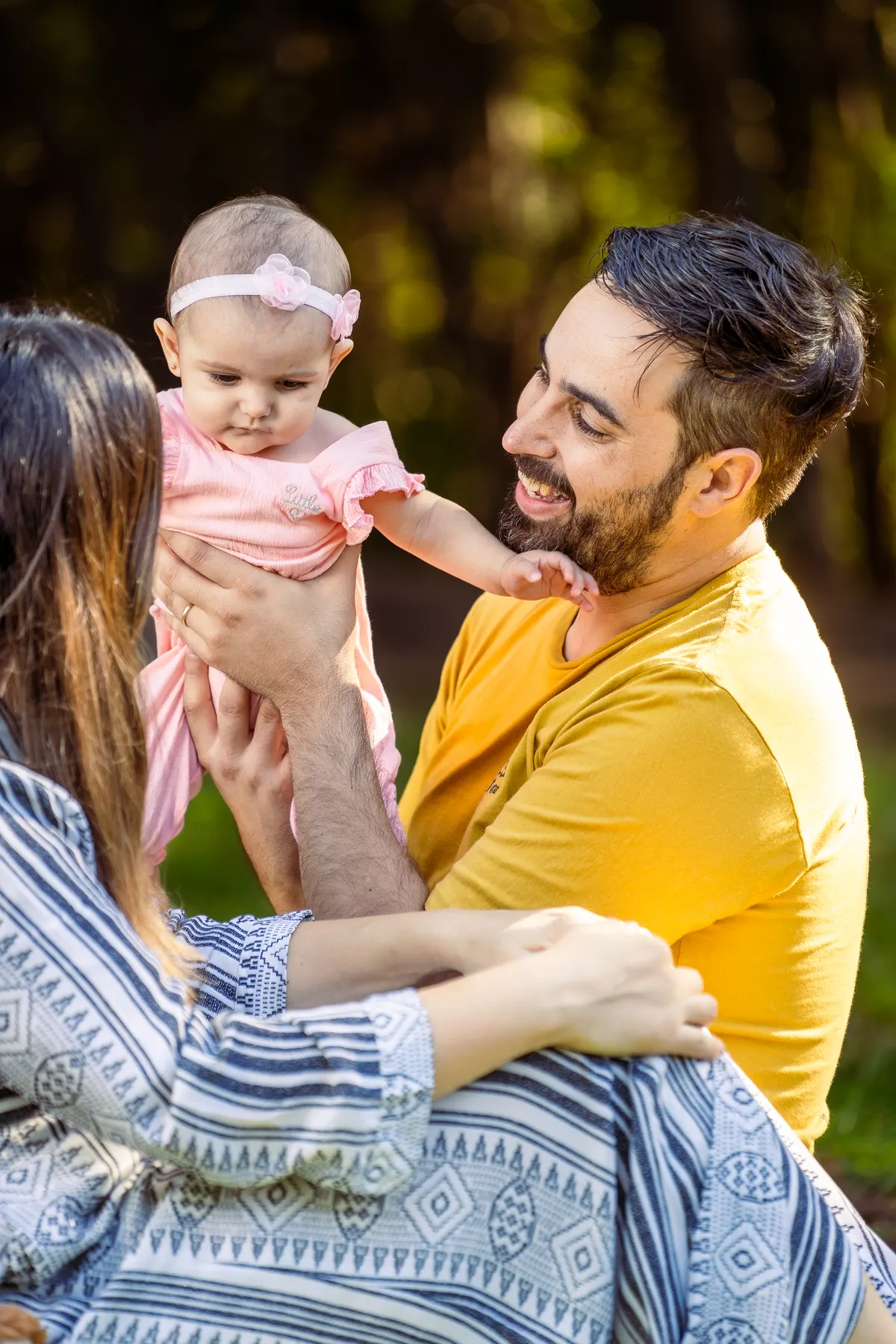 Parents enjoying time outdoors with their baby daughter